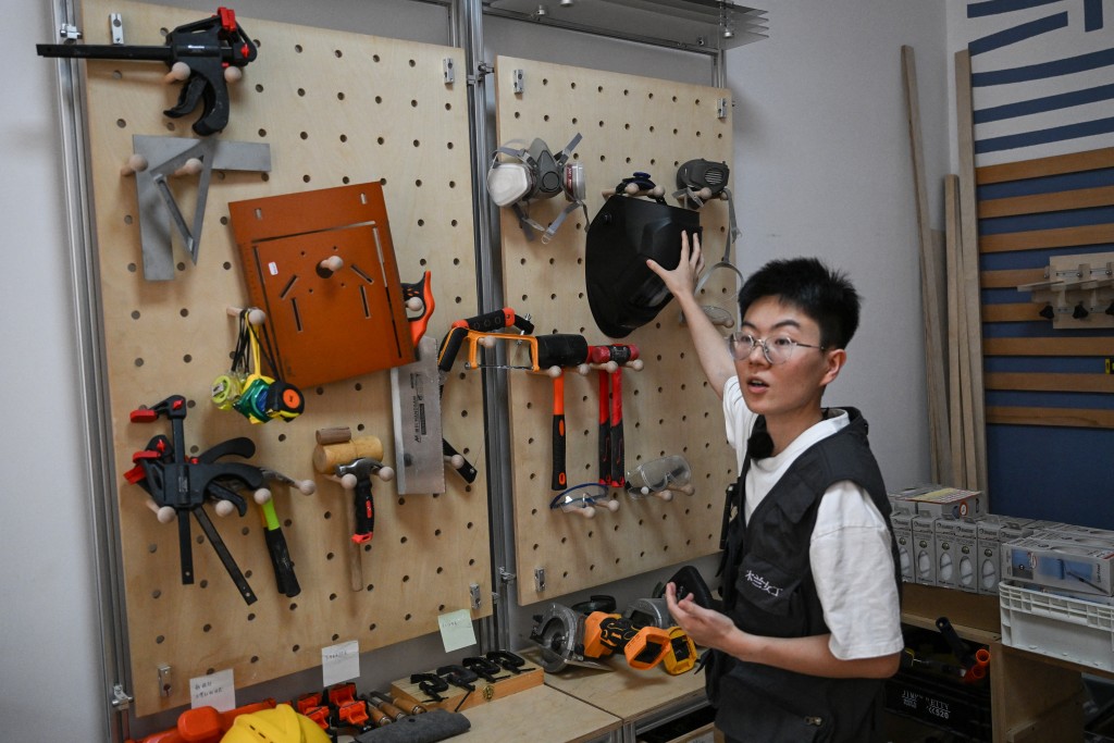 Photo by PEDRO PARDO / AFP  This picture taken on June 28, 2026 shows Chen Ning, the founder of the Mulan Build project, working in her workshop in Hangzhou, in eastern China's Zhejiang province.