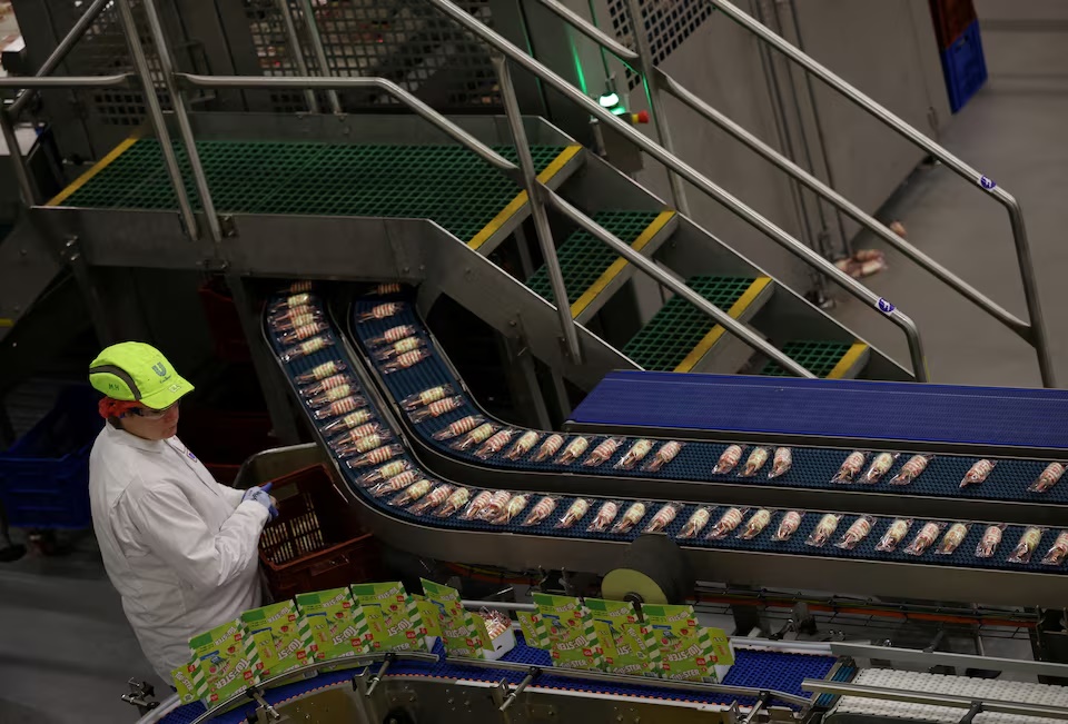 An employee works on the Twister ice cream production line at Unilever Wall's factory in Gloucester, Britain, November 21, 2025. REUTERS/Isabel Infantes/File Photo