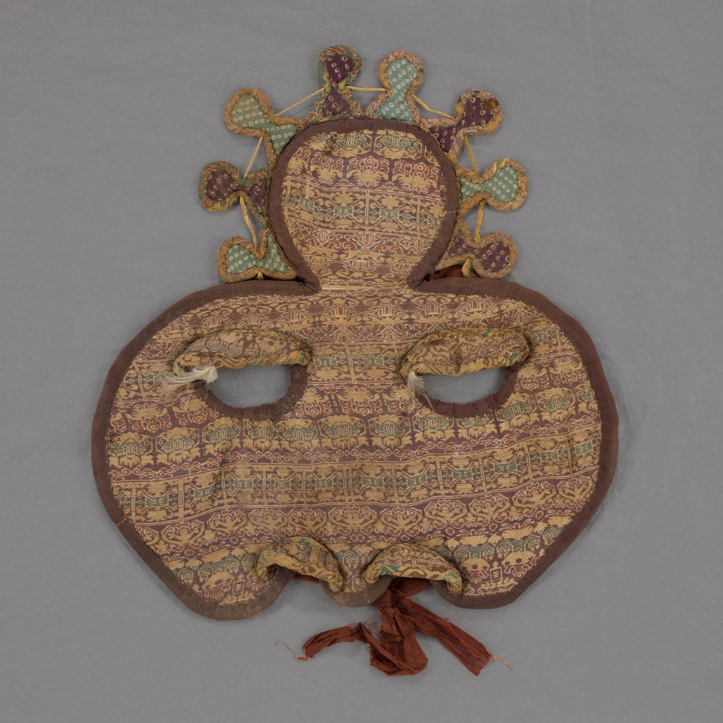 Shaffron (horse's face covering) with auspicious plants and geometric decorations Northern dynasties, 5th to 6th century Weft-faced compound tabby (taqueté), polychrome silk threads, and feathers The Chris Collection at the Hong Kong Palace Museum, 2025.CH-HKPM.232
