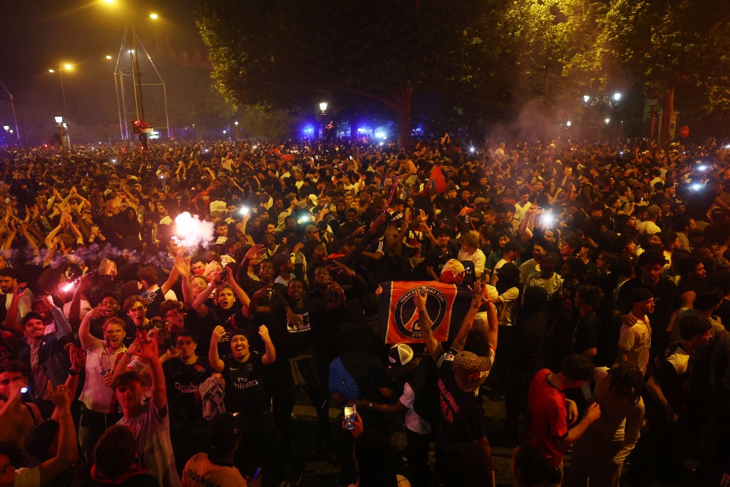 Paris St Germain fans celebrate on the Champs Elysees avenue after winning the Champions League. (Reuters)