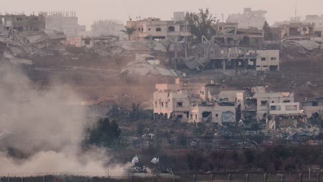 Military vehicles manoeuvre in Gaza, as seen from the Israeli side of the border, June 10, 2025. REUTERS/Amir Cohen/File Photo