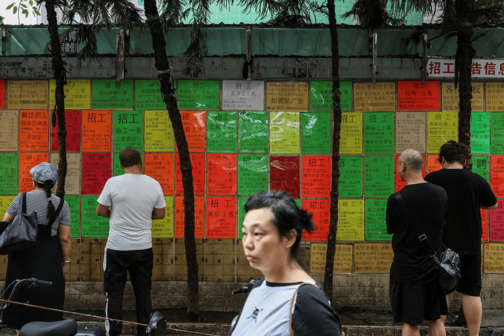People look at job advertisements on a wall in Datang Subdistrict, Guangzhou, Guangdong province, China May 10, 2025. REUTERS/Go Nakamura/ File Photo