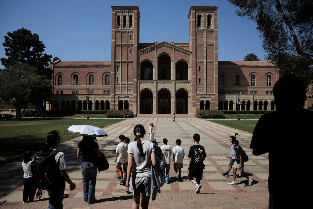 People walk through the campus of the University of California Los Angeles (UCLA) in Los Angeles, California, U.S., August 11, 2025. REUTERS/Daniel Cole/File Photo