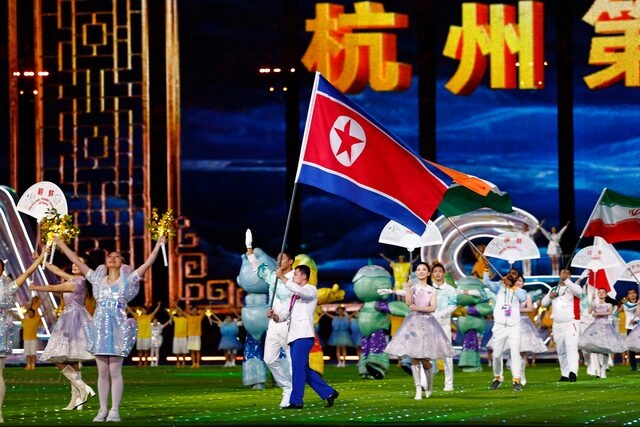Asian Games - Hangzhou 2022 - Closing Ceremony - Hangzhou Olympic Sports Centre Stadium, Hangzhou, China - October 8, 2023 A representative of North Korea's team walks with their national flag during the closing ceremony REUTERS/Tingshu Wang/File Photo