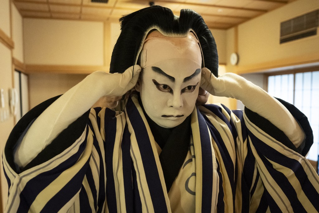 Photo by YUICHI YAMAZAKI / AFP  This picture taken on April 13, 2026 shows kabuki wig master Tadashi Kamoji (not pictured) helping kabuki actor Tanenosuke Nakamura to put on his wig before his performance at the Kabuki-za Theatre in Tokyo