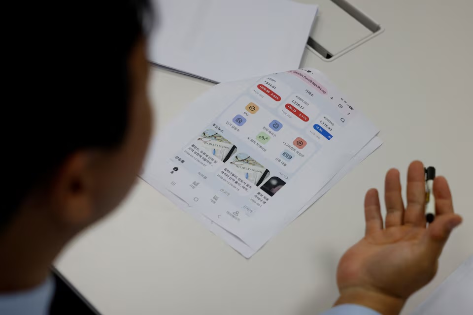  Lawyer Lee Tae-kyung shows a printout of screenshots from what he describes as a fake trading platform created by scammers behind an online stock-tipping chatroom during an interview with Reuters at a lawyer's office in Seoul, South Korea, August 10, 2026. REUTERS/Kim Soo-hyeon