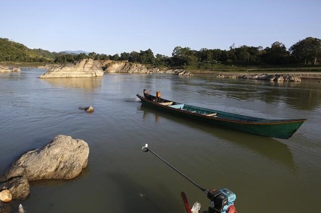A man steers his boat at Myitsone, outside Myitkyina, the capital city of Kachin state, in northern Myanmar December 18, 2014. REUTERS/Soe Zeya Tun/Files