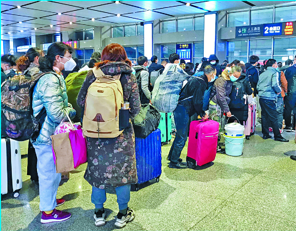 Passengers wait for trains in Hubei while Beijing supermarket workers get tested on the first day of eased Covid curbs.  AFP, AP