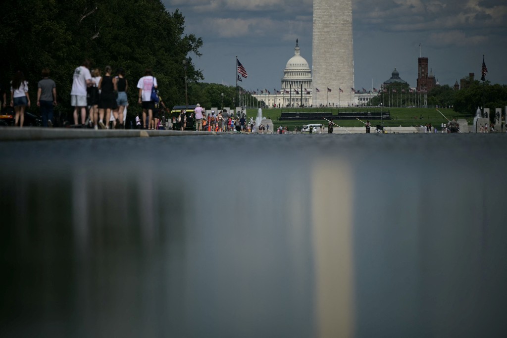 Workers using a water pump removes algae from the Lincoln Memorial Reflecting Pool following the completion of recent renovations in Washington, DC, on June 18, 2026. (Photo by Oliver Contreras / AFP)