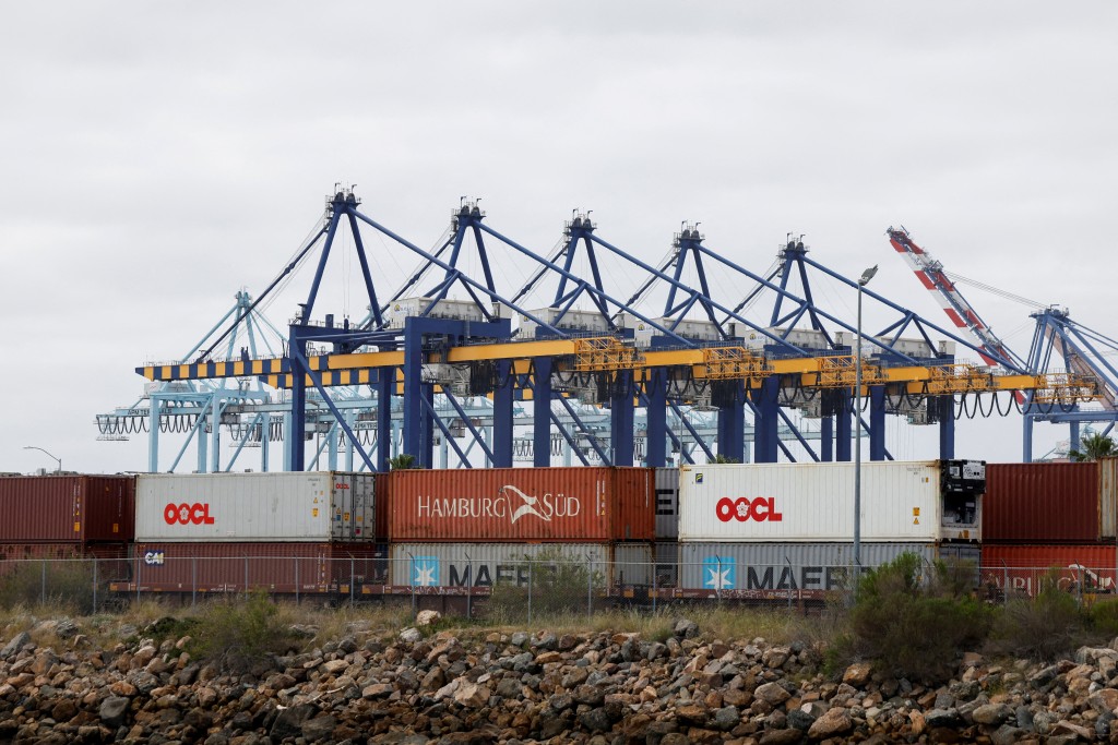 Shipping containers wait to be transported along a railroad at the port of Los Angeles in Long Beach, California, U.S., March 10, 2026. REUTERS