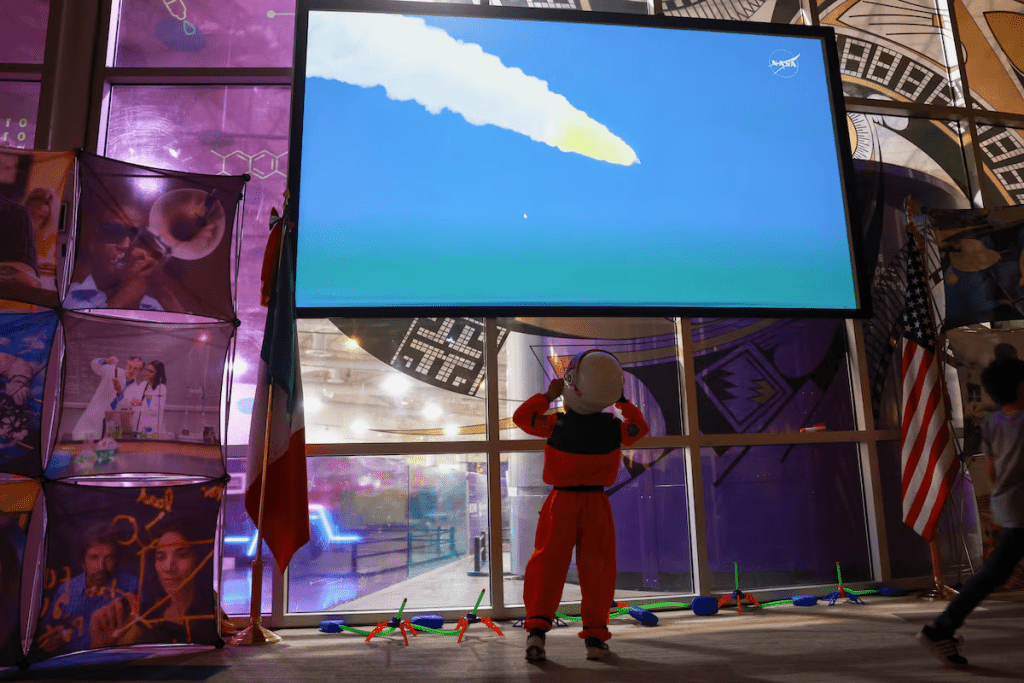 Bruno, dressed as an astronaut, gets excited as he watches the live broadcast of the launch of NASA's Artemis II mission to fly by the moon, during an event organized by the U.S. Consulate General in Mexico, at La Rodadora museum in Ciudad Juarez, Mexico, April 1, 2026. REUTERS/Jose Luis Gonzalez