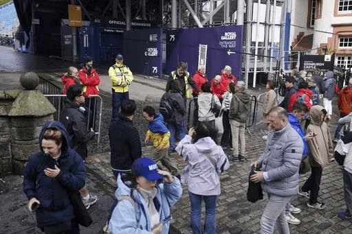 Members of the public are turned away from Edinburgh Castle as the site is closed to visitors due to high winds, in Scotland, Monday Aug. 4, 2025, as weather warnings are coming into force with Storm Floris expected to cause severe travel disruption to road, air and ferry services, and close bridges. (Jane Barlow/PA via AP)