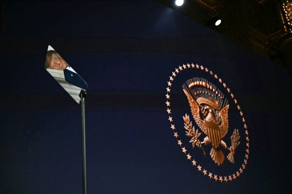 US President Donald Trump is reflected in a teleprompter as he attends an event to unveil the new America.gov website, at the Andrew W. Mellon Auditorium in Washington, DC, on September 29, 2026. (Photo by Kent NISHIMURA / AFP)