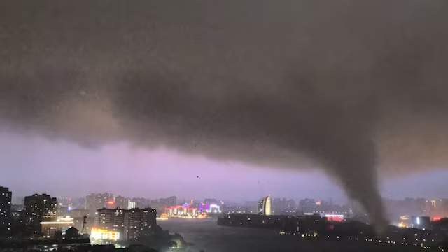 A tornado moves through an area amid lightning and strong winds, in Ezhou, Hubei province, China, July 6, 2026 in this screen grab obtained from social media video. Social Media/via REUTERS 