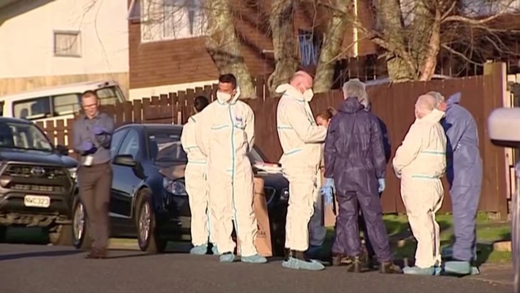 Police and forensic investigators gather at the scene where suitcases with the remains of two children were found in Auckland, New Zealand. TVNZ/Reuters
