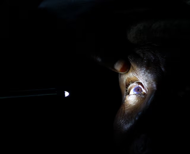 FILE PHOTO: An eye attendant examines the eye of a patient at a temporary clinic by International Centre for Eye Health at Olenguruone in the Mau Summit 350km (217 miles) west of Kenya's capital Nairobi, October 29, 2013. REUTERS/Noor Khamis
