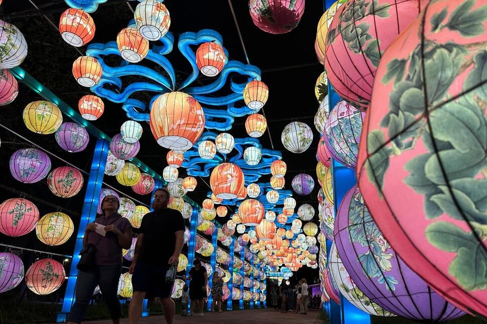 Visitors walk through a lighted tunnel at the Philadelphia Chinese Lantern Festival, Tuesday, Aug. 5, 2025 in Philadelphia. (AP Photo/Tassanee Vejpongsa)