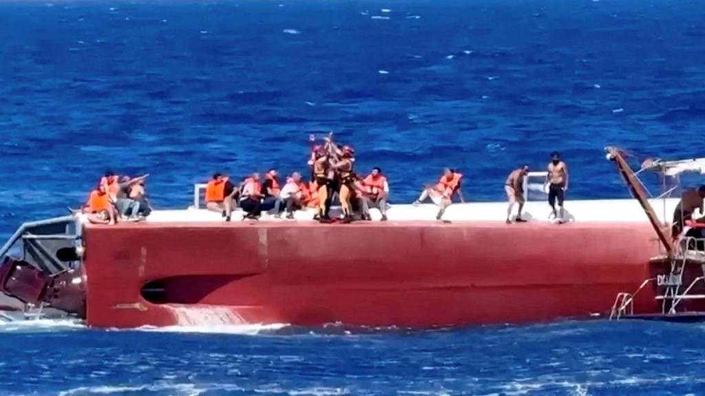 A passenger is rescued off a private ferry that capsized off the coast of Northern Cyprus. Reuters