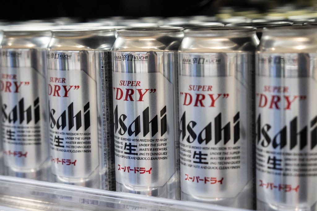 Asahi Super Dry beers are seen on display at a supermarket in Tokyo on October 3, 2025. Asahi Group Holdings, a major beer company, announced that it had experienced a system failure due to a cyber attack. (Photo by Yuichi YAMAZAKI / AFP)