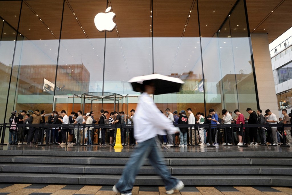 People line up outside an Apple store in Beijing, China. REUTERS