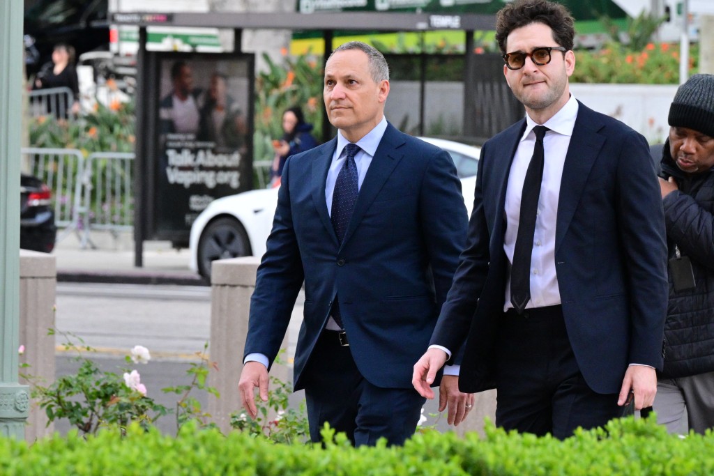 YouTube vice president of Engineering Cristos Goodrow (L) arrives to Los Angeles Superior Court for the social media trial tasked to determine whether social media giants deliberately designed their platforms to be addictive to children, in Los Angeles, on February 23, 2026. arrival to court for social media trial (Photo by Frederic J. Brown / AFP)