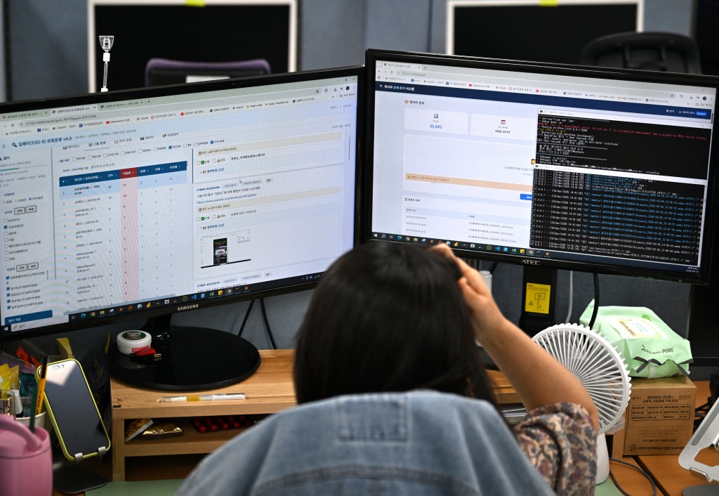 Photo by JUNG YEON-JE / AFP  This picture taken on April 16, 2026, shows a worker searching for fake content through social media related to election campaigns at the headquarters of the National Election Commission (NEC) in Gwacheon.