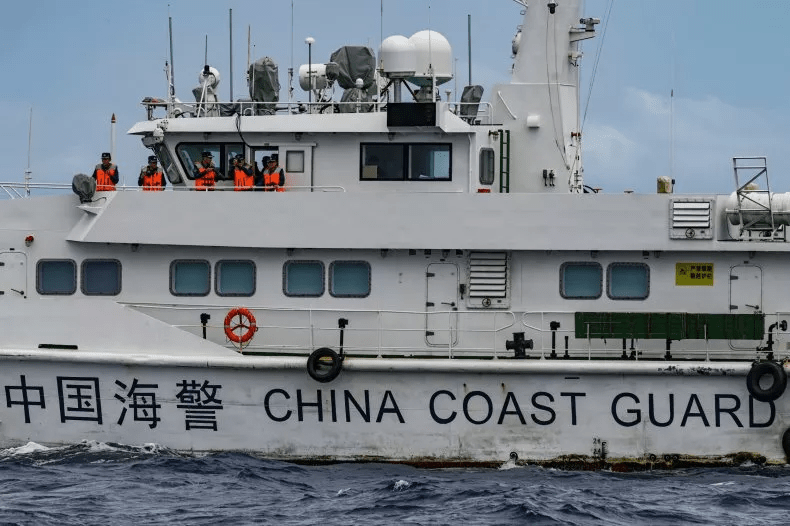 Personnel on board a China Coast Guard ship are seen from the Philippine Coast Guard vessel BRP Cabra during a supply mission to Sabina Shoal in disputed waters of the South China Sea on August 26. The shoal has become the latest flashpoint in the neighbors' long-running territorial dispute. Jam Sta Rosa/AFP via Getty Images Personnel on board a China Coast Guard ship are seen from the Philippine Coast Guard vessel BRP Cabra during a supply mission to Sabina Shoal in disputed waters of the South China Sea on August 26. The shoal has become the latest flashpoint in the neighbors' long-running territorial dispute. Jam Sta Rosa/AFP via Getty Images