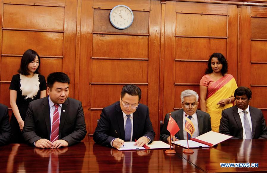 Cheng Xueyuan, the then Chinese ambassador to Sri Lanka, center left, and R.H.S. Samarathunga, center right, secretary to Treasury and the Ministry of Finance and Mass Media of Sri Lanka sign a concessional loan agreement in Colombo, Sri Lanka on March 22, 2019, with the Export-Import Bank of China (China Exim Bank) on a expressway project. Cheng Xueyuan, the then Chinese ambassador to Sri Lanka, center left, and R.H.S. Samarathunga, center right, secretary to Treasury and the Ministry of Finance and Mass Media of Sri Lanka sign a concessional loan agreement in Colombo, Sri Lanka on March 22, 2019, with the Export-Import Bank of China (China Exim Bank) on a expressway project.