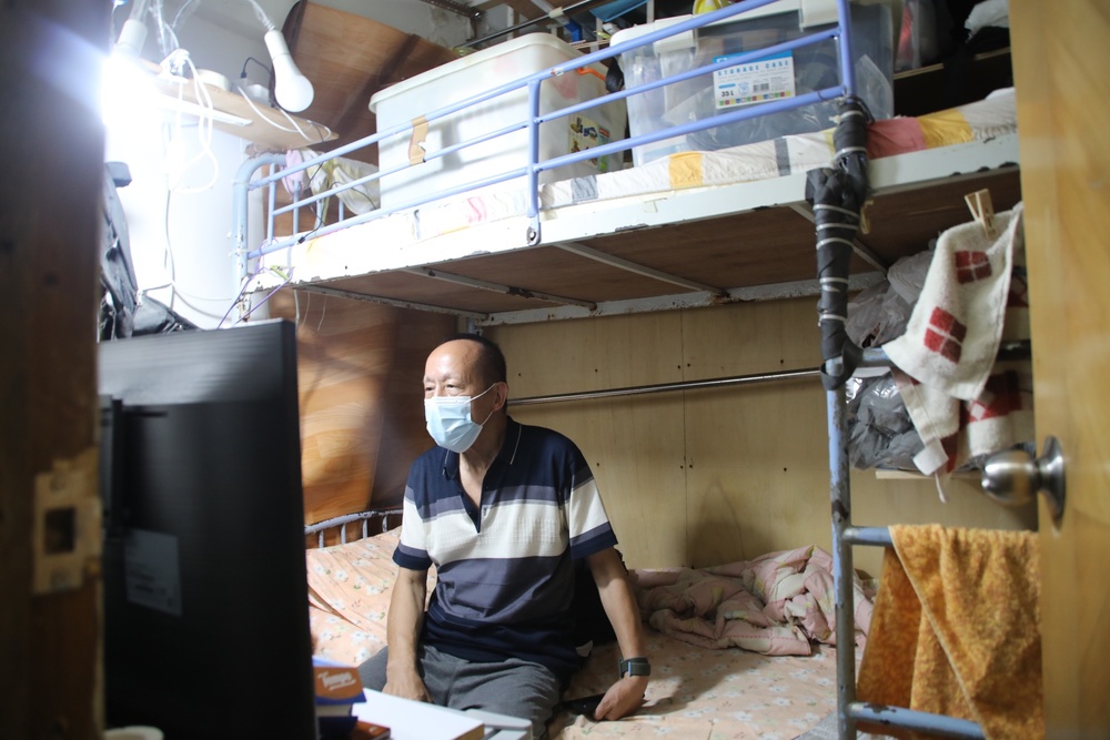 Tong Fei Yeung’s windowless room is typical of the city’s many subdivided apartments spaces. (Bloomberg) 