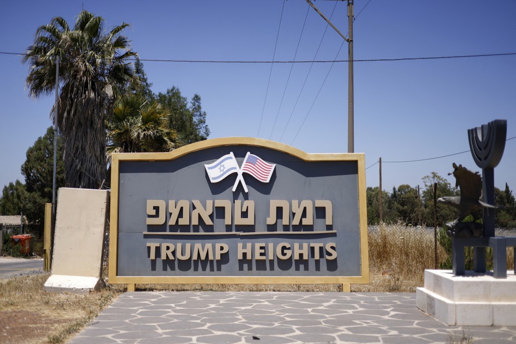 Photo by JALAA MAREY / AFP  The sign reading "Ramat Trump / Trump Heights" is displayed at the entrance of Ramat Trump Moshav in the Israeli-annexed Golan Heights on June 19, 2026.
