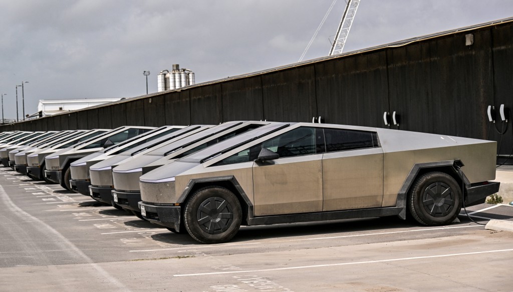 A fleet of Tesla Cyber Trucks are plugged into charging stations outside the SpaceX production facility in Starbase, Texas, U.S., May 17, 2026.REUTERS