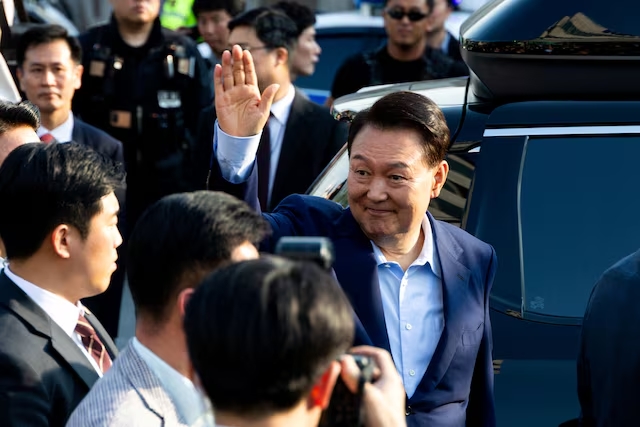 Ousted former South Korean President Yoon Suk Yeol waves to his supporters as he moves out of the presidential residence in Seoul, South Korea, April 11, 2025. (Reuters)