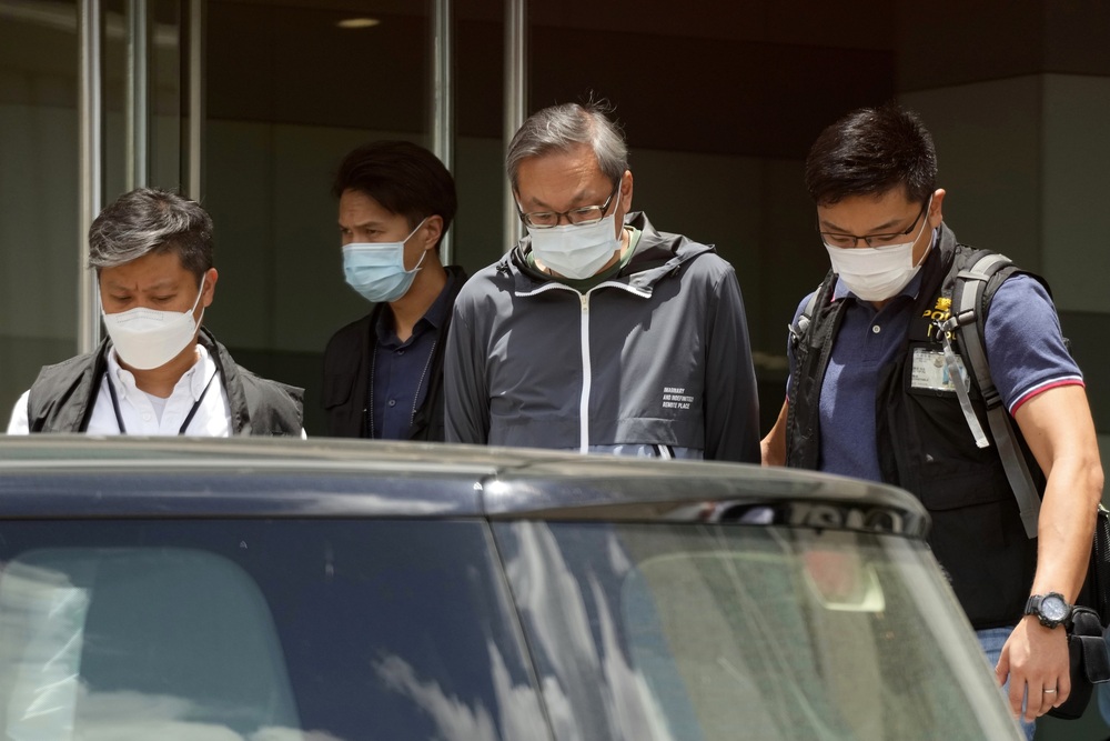 Police officers escort Cheung Kim-hung, right, CEO and Executive Director of Next Digital Ltd at Apple Daily headquarters in Hong Kong, Thursday, June 17, 2021. (AP) Police officers escort Cheung Kim-hung, right, CEO and Executive Director of Next Digital Ltd at Apple Daily headquarters in Hong Kong, Thursday, June 17, 2021. (AP)