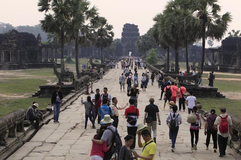 FILE - Tourists visit the Angkor Wat temple in Siem Reap, Cambodia, on March 14, 2018. The human rights group Amnesty International in a report released Tuesday Nov. 14, 2023 has strongly criticized the U.N. cultural agency UNESCO and its World Heritage program for failing to challenge the Cambodian government’s ongoing mass evictions at the world famous centuries-old Angkor Wat temple complex. (AP Photo/Heng Sinith, File) FILE - Tourists visit the Angkor Wat temple in Siem Reap, Cambodia, on March 14, 2018. The human rights group Amnesty International in a report released Tuesday Nov. 14, 2023 has strongly criticized the U.N. cultural agency UNESCO and its World Heritage program for failing to challenge the Cambodian government’s ongoing mass evictions at the world famous centuries-old Angkor Wat temple complex. (AP Photo/Heng Sinith, File)