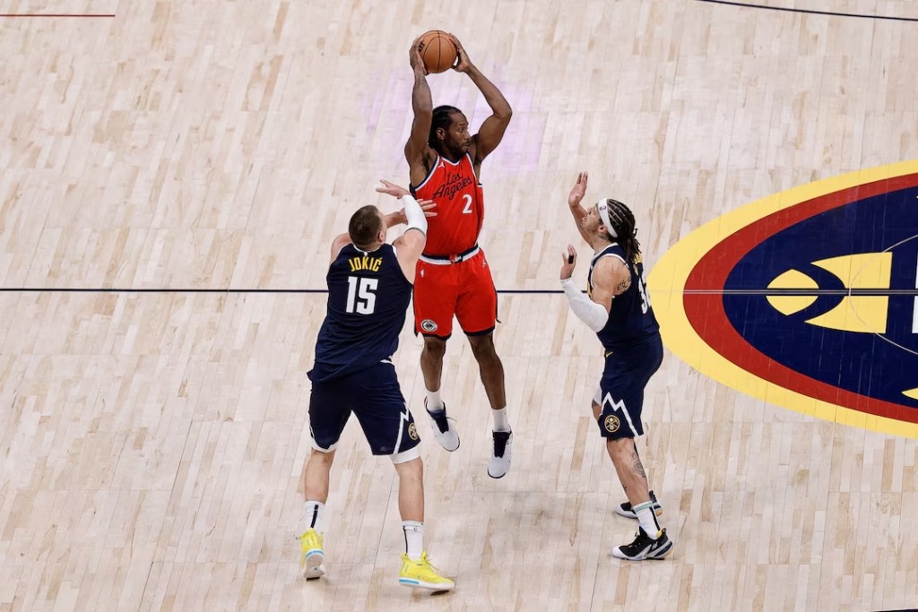 Los Angeles Clippers forward Kawhi Leonard (2) controls the ball as Denver Nuggets center Nikola Jokic (15) and forward Aaron Gordon (32) defend in the fourth quarter during game two of first round for the 2025 NBA Playoffs at Ball Arena. (Reuters)