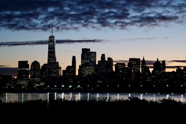 The skyline of Lower Manhattan is seen at dawn from across the Hudson River in New York City, U.S., October 18, 2025. REUTERS/Kevin Coombs
