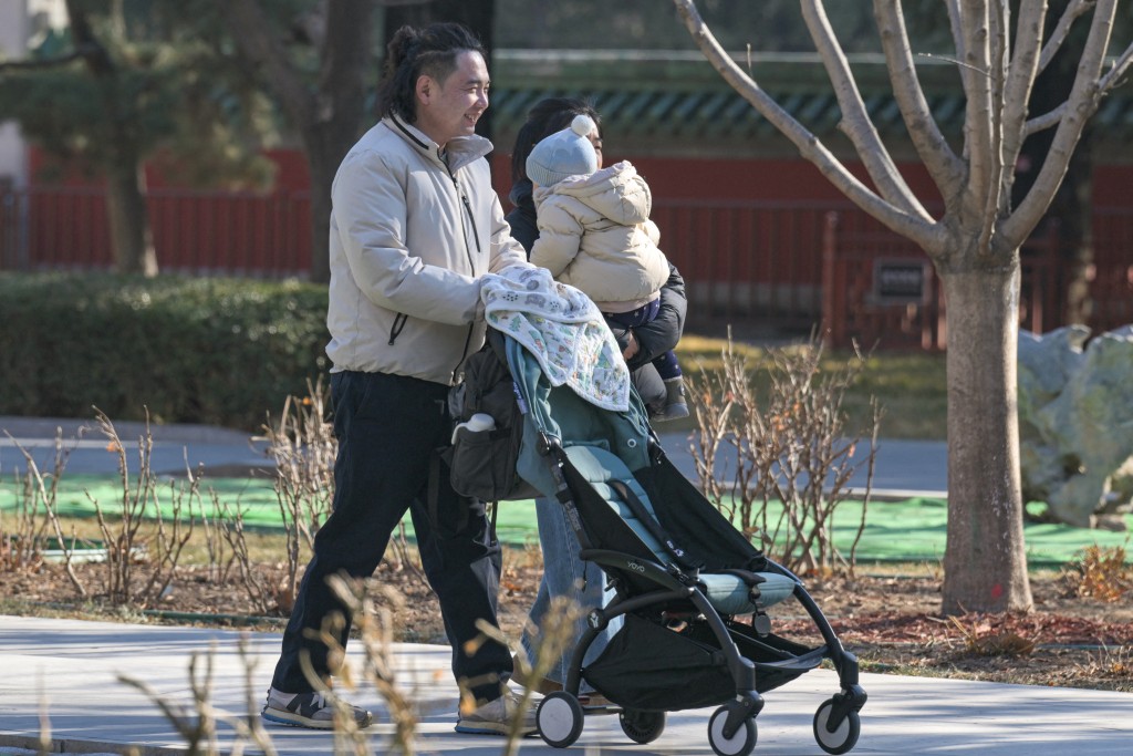 A family is pictured at a park in Beijing on January 3, 2026. (AFP)