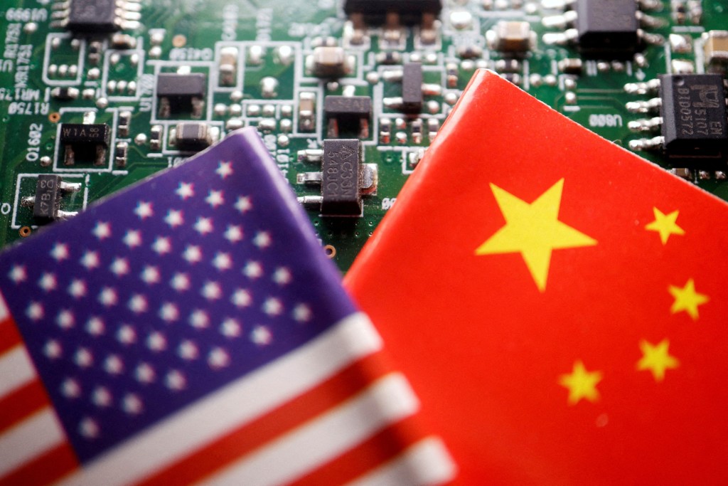 Flags of China and U.S. are displayed on a printed circuit board with semiconductor chips in this illustration picture. (Reuters)