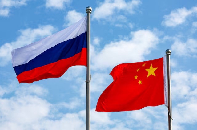 Chinese and Russian flags fly at an airport before a ceremony to welcome Russian President Vladimir Putin, who arrives to attend the Shanghai Cooperation Organisation (SCO) summit in Tianjin, China August 31, 2025. Sputnik/Vladimir Smirnov/Pool via REUTERS