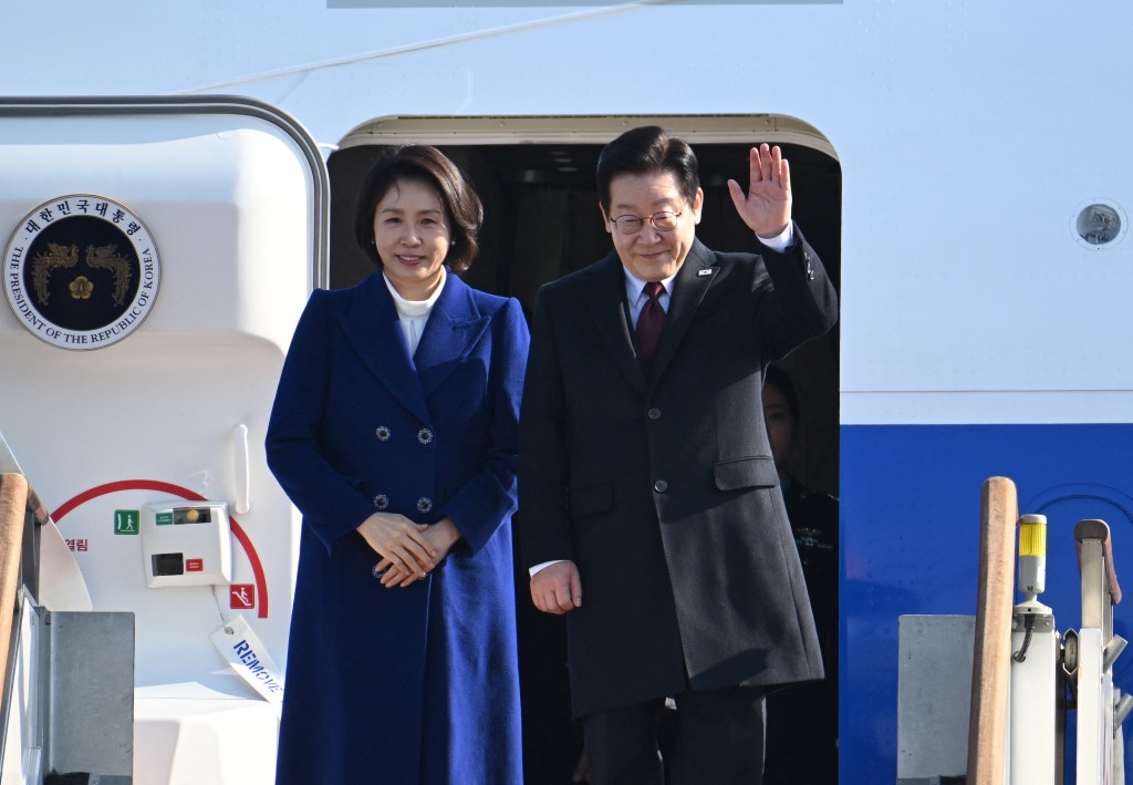 South Korea’s President Lee Jae Myung (R) and his wife Kim Hea Kyung (L) board their plane to depart for China at Seoul Air Base in Seongnam on January 4, 2026. (AFP)