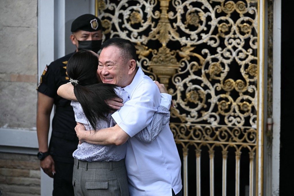 Thailand's former prime minister Thaksin Shinawatra (R) hugs his daughter Paetongtarn Shinawatra upon his release at Klong Prem Central Prison in Bangkok on May 11, 2026. (AFP)