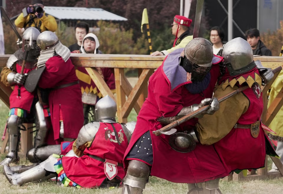 Spectators watch as participants dressed in historical plate armour fight during the Quanjia Fighting Open Championship, a full-contact medieval combat tournament in Beijing, China, October 24, 2026. REUTERS/Mandy Leong 
