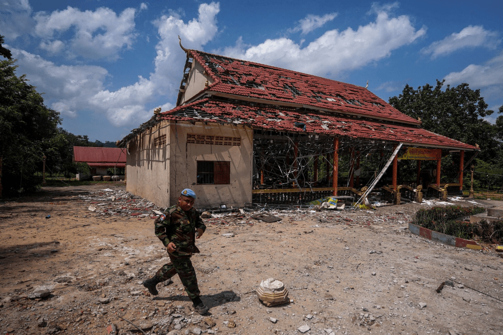 A Cambodian soldier walks past a building, damaged by an artillery, during a visit of delegation of foreign diplomats to inspect a damaged area along the Thailand-Cambodia's border, following a ceasefire between Cambodia and Thailand, in Oddar Meanchey, Cambodia, August 1, 2025. REUTERS/Soveit Yarn