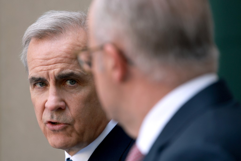 Canada's Prime Minister Mark Carney (L) speaks to Australia's Prime Minister Anthony Albanese during a press conference at Parliament House in Canberra on March 5, 2026. (AFP)