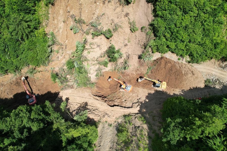 An aerial drone photo taken on July 7, 2026 shows rescuers working at the site of a landslide in a village in Nanhe Township, Tanchang County, Longnan City, northwest China's Gansu Province. (Xinhua/Fan Peishen)