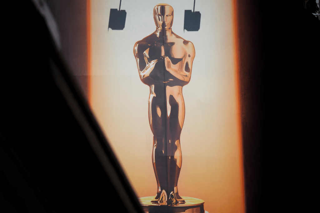 A large billboard sign featuring an Oscar statuette towers over Hollywood blvd as workers prepare for the 98th Academy Awards in Los Angeles, California, U.S., March 9, 2026. REUTERS/Daniel Cole