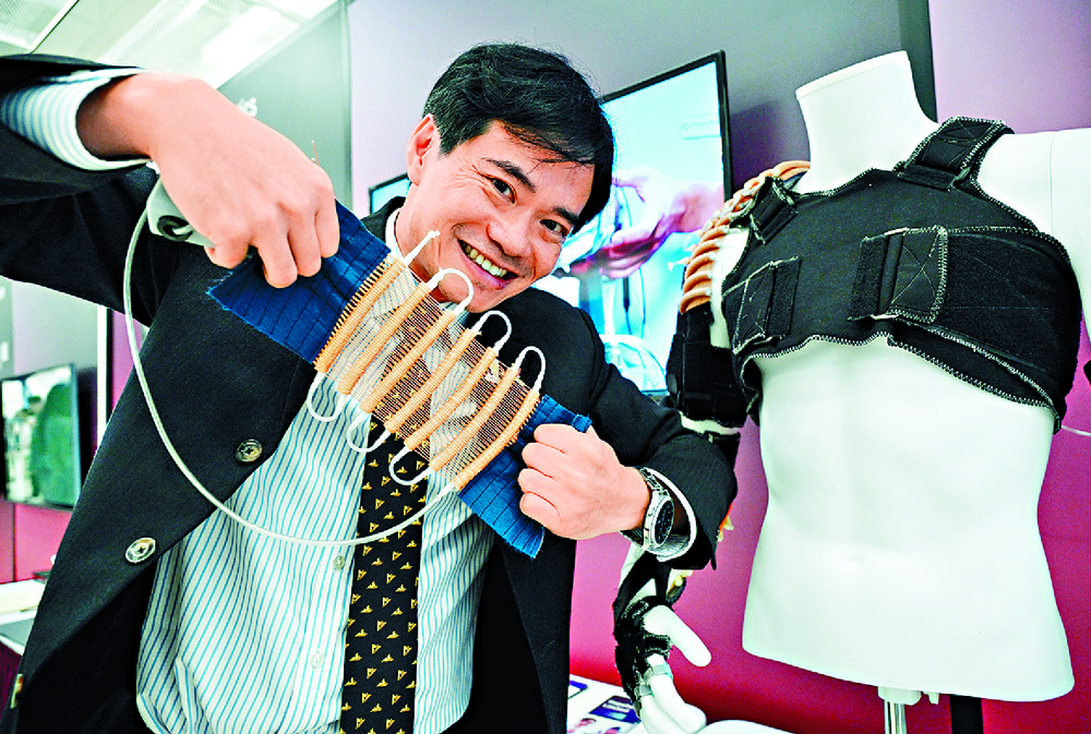 Raymond Tong shows how the wearable robotic technology works. Raymond Tong shows how the wearable robotic technology works.