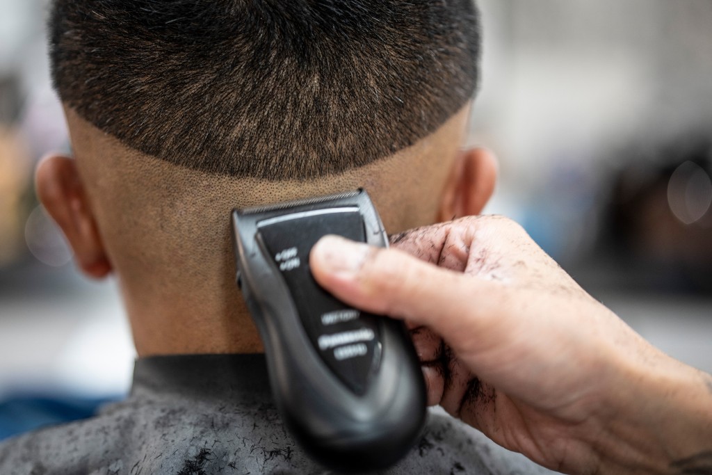 Photo by YUICHI YAMAZAKI / AFP  This photo taken on August 27, 2026 shows Tekisasu, an active yakuza gangster allied to a major clan, having his hair cut at a barbershop in Tokyo.