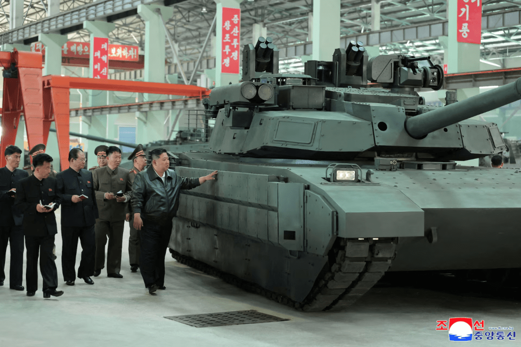 North Korea's leader Kim Jong Un touches tank armour as he tours a military equipment facility at an unspecified location in North Korea, in this image released May 4, 2025 by the Korean Central News Agency. (KCNA via REUTERS)