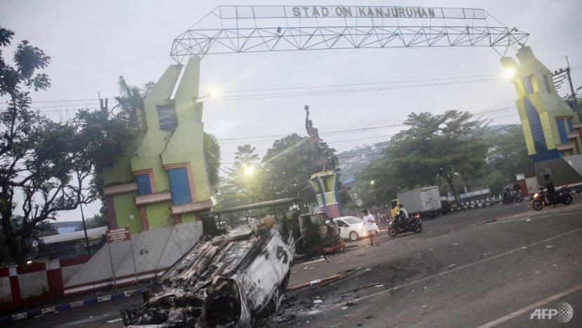 A torched car outside Kanjuruhan stadium in Malang, East Java on Oct 2, 2022. More than 120 people were killed when angry fans invaded a football pitch after a match in Malang, East Java in Indonesia. (AFP)